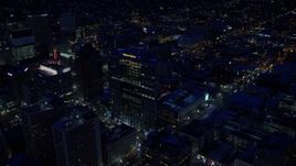 5.5K aerial stock footage orbit Wells Fargo Building to reveal Gallivan Center with winter snow at night, Downtown Salt Lake City, Utah Aerial Stock Footage | AX128_089E