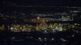 5.5K aerial stock footage orbiting a large Salt Lake City refinery at night in winter, Utah Aerial Stock Footage | AX128_112