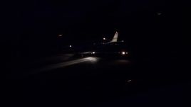 5.5K aerial stock footage track private jet touching down at SLC Airport at night in winter, Utah Aerial Stock Footage | AX128_114E