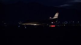 5.5K aerial stock footage track private jet taxiing off SLC Airport runway at night in wintertime, Utah Aerial Stock Footage | AX128_121E