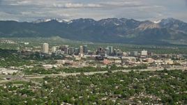 5.5K aerial stock footage of flying by the city, Wasatch Range in the distance, Downtown Salt Lake City, Utah Aerial Stock Footage | AX129_003E
