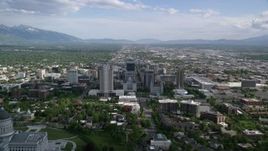 5.5K aerial stock footage of passing by city buildings, Utah State Capitol Dome, Downtown Salt Lake City, Utah Aerial Stock Footage | AX129_009