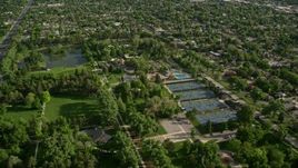 5.5K aerial stock footage of flying over Liberty Park, tennis courts, approaching suburbs, Salt Lake City, Utah Aerial Stock Footage | AX129_022