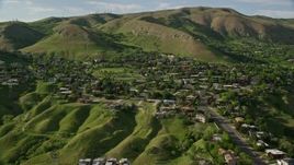 5.5K aerial stock footage of flying by suburban neighborhood, Wasatch Range foothills, Salt Lake City, Utah Aerial Stock Footage | AX129_058