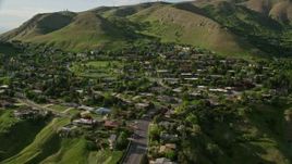 5.5K aerial stock footage of flying by hilltop suburban neighborhood, Wasatch Range, Salt Lake City, Utah Aerial Stock Footage | AX129_059