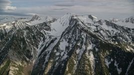 5.5K aerial stock footage of an approach to snow-covered ridges, peaks, Wasatch Range, Utah Aerial Stock Footage | AX129_110E