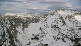 5.5K aerial stock footage of flying by snow-covered mountain ridges, Wasatch Range, Utah Aerial Stock Footage | AX129_113