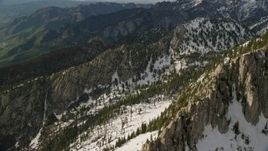 5.5K aerial stock footage pan across Lone Peak in snowy Wasatch Range, Lone Peak, Utah Aerial Stock Footage | AX129_124