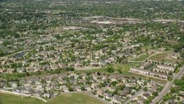5.5K aerial stock footage of approaching suburban neighborhood, tilt to rooftops, West Jordan, Utah Aerial Stock Footage | AX130_020E