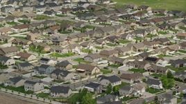 5.5K aerial stock footage of flying by suburban tract homes, West Jordan, Utah Aerial Stock Footage | AX130_028