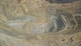 5.5K aerial stock footage pan and fly away from gravel haulers, Bingham Canyon Mine, Utah Aerial Stock Footage | AX130_057