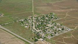 5.5K aerial stock footage of flying by small rural neighborhood in Cedar Fort, Utah Aerial Stock Footage | AX130_076E