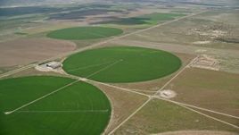 5.5K aerial stock footage of approaching circular crop fields and tilt to one of them, Elberta, Utah Aerial Stock Footage | AX130_093E
