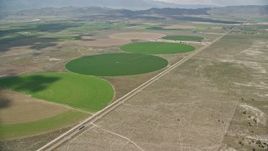 5.5K aerial stock footage of approaching, flying over large circular crop fields, Elberta, Utah Aerial Stock Footage | AX130_095E