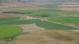 5.5K aerial stock footage of flying by large field of circular crop fields, Elberta, Utah Aerial Stock Footage | AX130_103E
