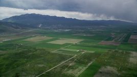 5.5K aerial stock footage of approaching small rural town, farmland, Nephi Municipal Airport, Nephi, Utah Aerial Stock Footage | AX130_115