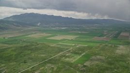 5.5K aerial stock footage of approaching small rural town, farmland, Nephi Municipal Airport, Nephi, Utah Aerial Stock Footage | AX130_115E