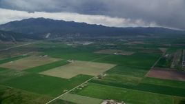 5.5K aerial stock footage of approaching small rural town, fly over farm fields, Nephi, Utah Aerial Stock Footage | AX130_116