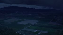 4K day for night color corrected aerial footage of approaching small rural town, fly over farm fields, Nephi, Utah Aerial Stock Footage | AX130_116_DFN