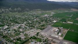 5.5K aerial stock footage of flying over small rural town, farm fields, Nephi, Utah Aerial Stock Footage | AX130_117