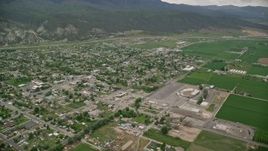 5.5K aerial stock footage of flying over small rural town by farm fields, Nephi, Utah Aerial Stock Footage | AX130_117E