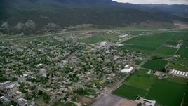 5.5K aerial stock footage of flying over small rural town by farm fields, Nephi, Utah Aerial Stock Footage | AX130_118