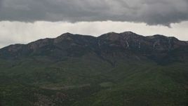 5.5K aerial stock footage of flying by a peak in the Wasatch Range, Salt Creek Peak, Utah Aerial Stock Footage | AX130_121E