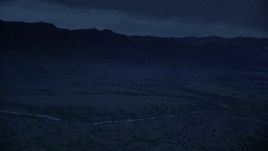 4K day for night color corrected aerial footage of approaching hills with clouds in the sky, Wasatch Range, Utah Aerial Stock Footage | AX130_125_DFN