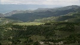 5.5K aerial stock footage of flying over green mountains, trees, Wasatch Range, Utah Aerial Stock Footage | AX130_129E
