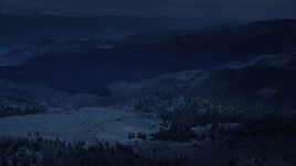 4K day for night color corrected aerial footage of flying over mountains, trees in Wasatch Range, Utah Aerial Stock Footage | AX130_129_DFN