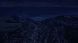 4K day for night color corrected aerial footage of approaching a valley beyond mountain peaks, Wasatch Range, Utah Aerial Stock Footage | AX130_133_DFN