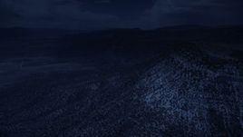 4K day for night color corrected aerial footage of flying by mountain peaks, slopes, trees, Wasatch Range, Utah Aerial Stock Footage | AX130_137_DFN