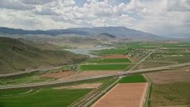 5.5K aerial stock footage of flying by small town, farmland, Highway 89 and Route 24 crossing, Rocky Ford Reservoir, Sigurd, Utah Aerial Stock Footage | AX130_176