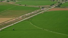5.5K aerial stock footage of following Route 118 through farmland, circular crop fields, Sigurd, Utah Aerial Stock Footage | AX130_180