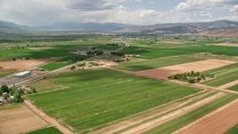 5.5K aerial stock footage of flying over farmland near Route 118, approach rural town, Richfield, Utah Aerial Stock Footage | AX130_191