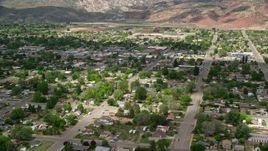 5.5K aerial stock footage of passing by shops, small town neighborhoods, Richfield, Utah Aerial Stock Footage | AX130_194E