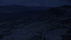 4K day for night color corrected aerial footage fly over tree-covered mountain slopes toward valley, Fishlake National Forest, Utah Aerial Stock Footage | AX130_204_DFN