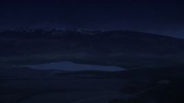 4K day for night color corrected aerial footage flyby Koosharem Reservoir, snowy mountains in background, Fishlake National Forest, Utah Aerial Stock Footage | AX130_210_DFN