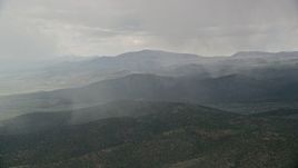 5.5K aerial stock footage of flying by rain falling on mountains, trees, Fishlake National Forest, Utah Aerial Stock Footage | AX130_214