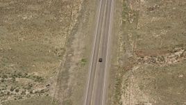 5.5K aerial stock footage of tracking a black SUV, country road, dry land, Loa, Utah Aerial Stock Footage | AX130_236