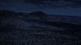 4K day for night color corrected aerial footage of flying by mesas, pan and approach a butte, Capitol Reef National Park, Utah Aerial Stock Footage | AX130_245_DFN