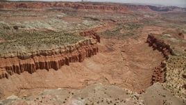 5.5K aerial stock footage of flying over dry riverbed through canyon between mesas, Capitol Reef National Park, Utah Aerial Stock Footage | AX130_250E