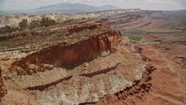 5.5K aerial stock footage flyby mesa cliffs, reveal and approach small butte, Waterpocket Fold, Capitol Reef National Park, Utah Aerial Stock Footage | AX130_261E
