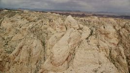 5.5K aerial stock footage pan and flyby the Waterpocket Fold rock formations, Capitol Reef National Park, Utah Aerial Stock Footage | AX130_283E