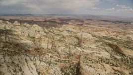 5.5K aerial stock footage passing the Waterpocket Fold rock formations, Capitol Reef National Park, Utah Aerial Stock Footage | AX130_285E
