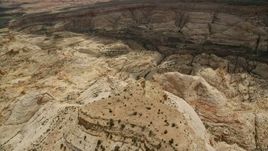 5.5K aerial stock footage of flying over a mesa, tilt to Waterpocket Fold rock formations, Capitol Reef National Park, Utah Aerial Stock Footage | AX130_296
