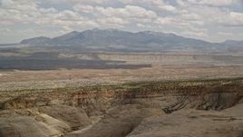 5.5K aerial stock footage of flying by distant mesas, mountains, Capitol Reef National Park, Utah Aerial Stock Footage | AX130_318