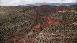 5.5K aerial stock footage flying by canyons, mesas, beside Waterpocket Fold, Capitol Reef National Park, Utah Aerial Stock Footage | AX130_326