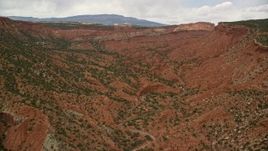 5.5K aerial stock footage of a wide red canyon with desert vegetation, Capitol Reef National Park, Utah Aerial Stock Footage | AX130_332E
