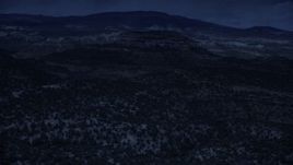 4K day for night color corrected aerial footage of approaching a desert peak, over desert vegetation, Capitol Reef National Park, Utah Aerial Stock Footage | AX130_338_DFN